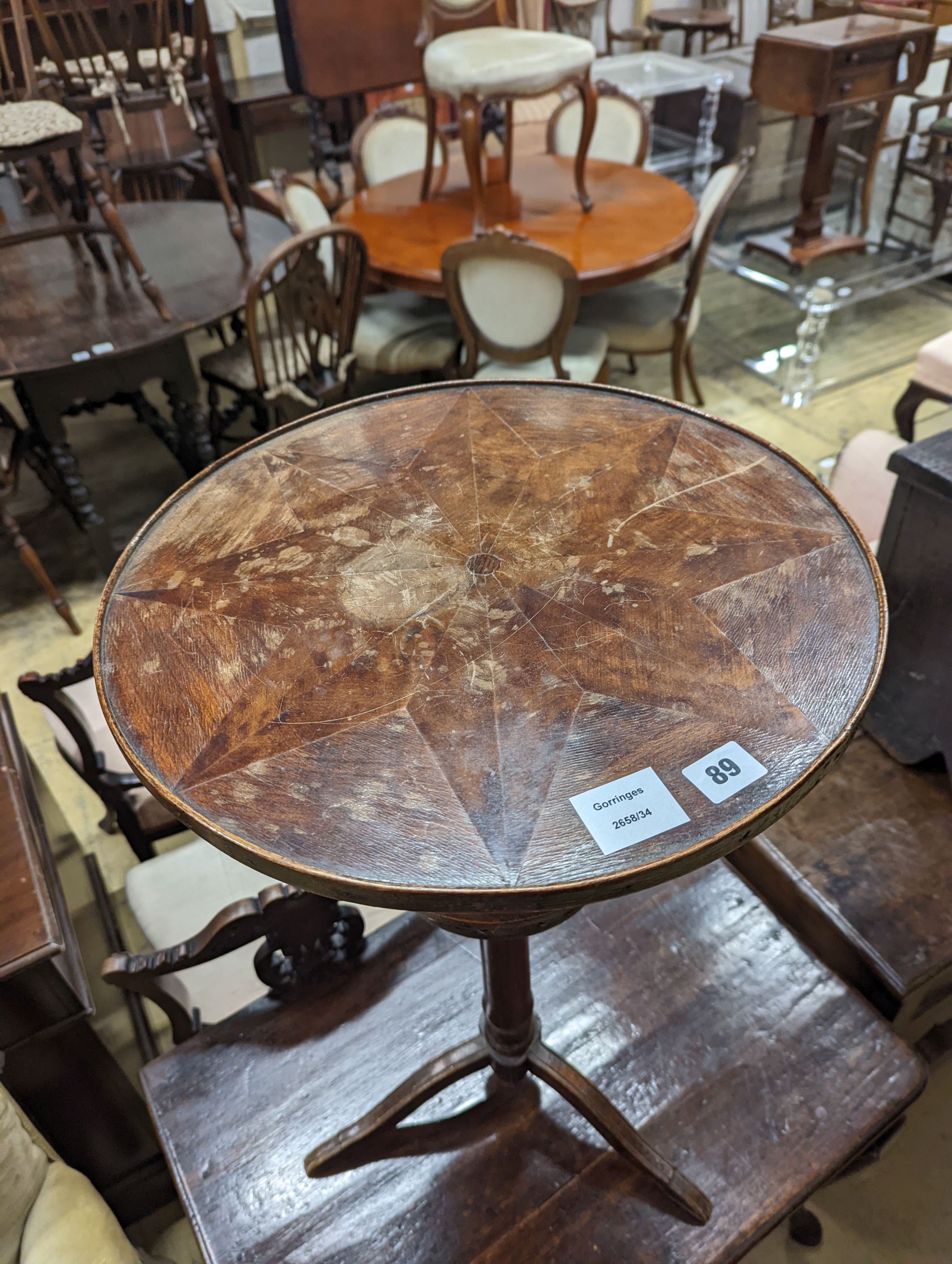 An early 19th century primitive circular tripod table, diameter 42cm, height 73cm